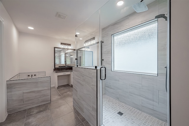 bathroom featuring walk in shower, vanity, and tile patterned floors