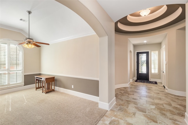 entryway with a tray ceiling, ornamental molding, and ceiling fan