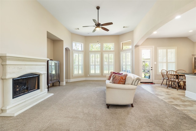 carpeted living room featuring ceiling fan and plenty of natural light