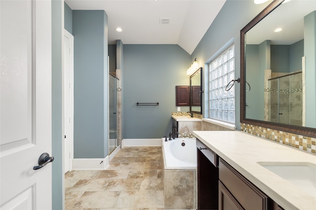 bathroom featuring vanity, plus walk in shower, and vaulted ceiling