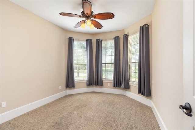 unfurnished room with ceiling fan and carpet flooring