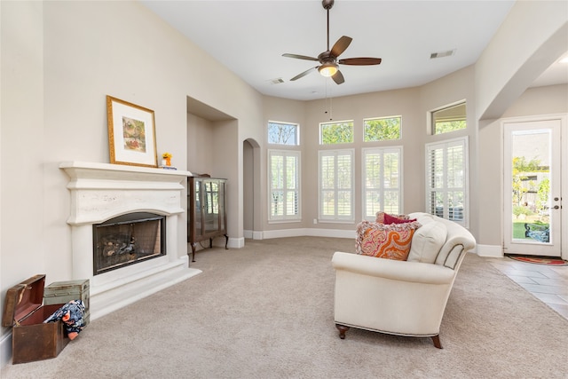 living room with light carpet and ceiling fan