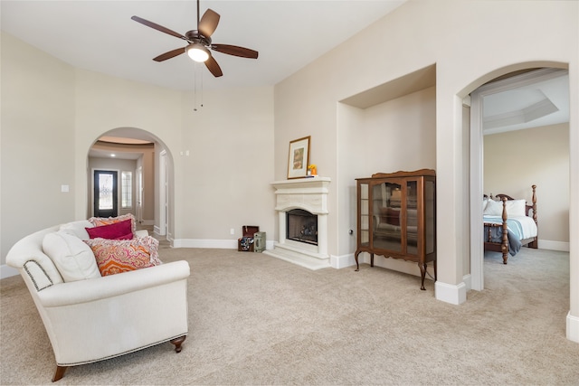 carpeted living room featuring ceiling fan