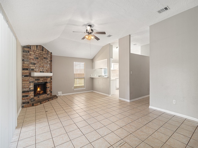 unfurnished living room with lofted ceiling, ceiling fan, a fireplace, and a textured ceiling