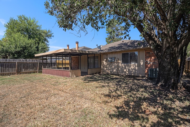 rear view of house with a lawn, cooling unit, and a pergola