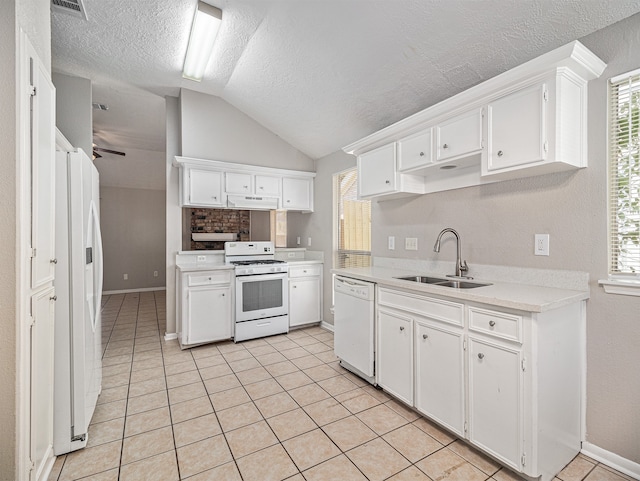 kitchen featuring vaulted ceiling, sink, white appliances, and white cabinetry