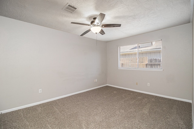 carpeted spare room with ceiling fan and a textured ceiling