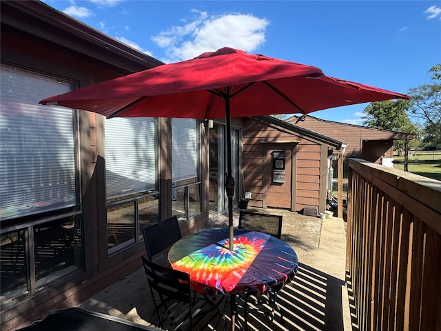 wooden terrace with a patio area