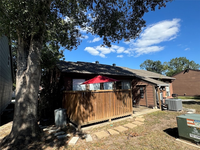 back of house with cooling unit