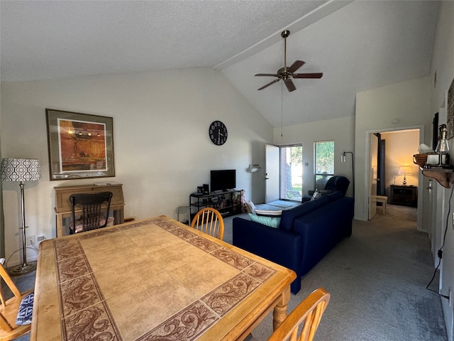 carpeted living room featuring ceiling fan, a textured ceiling, and high vaulted ceiling