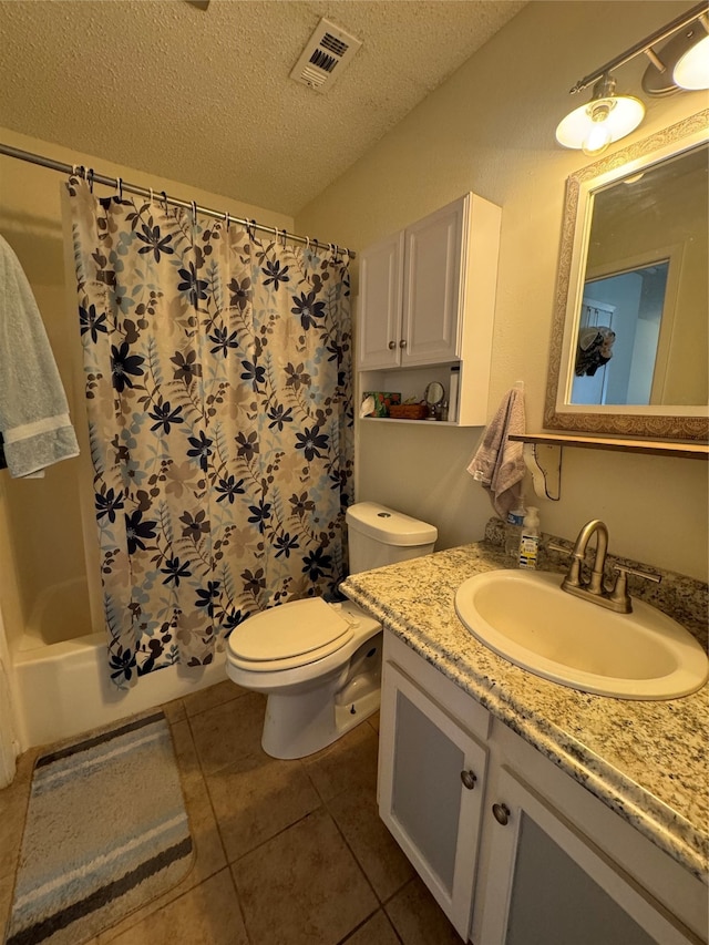 full bathroom featuring vanity, a textured ceiling, shower / bath combo, toilet, and tile patterned floors