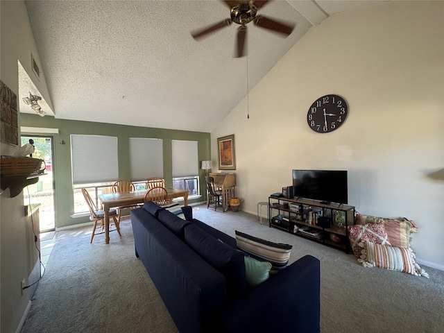 living room featuring ceiling fan, a textured ceiling, carpet flooring, and high vaulted ceiling