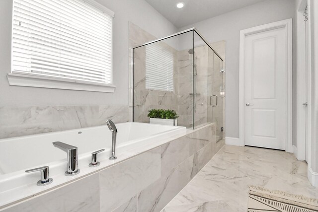 bathroom featuring independent shower and bath