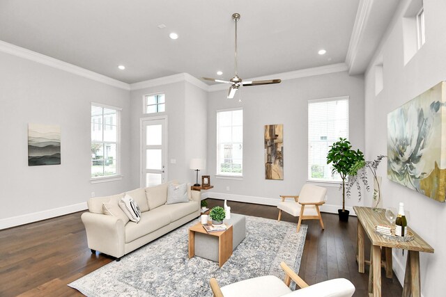 living room featuring dark wood-type flooring, ornamental molding, and a healthy amount of sunlight