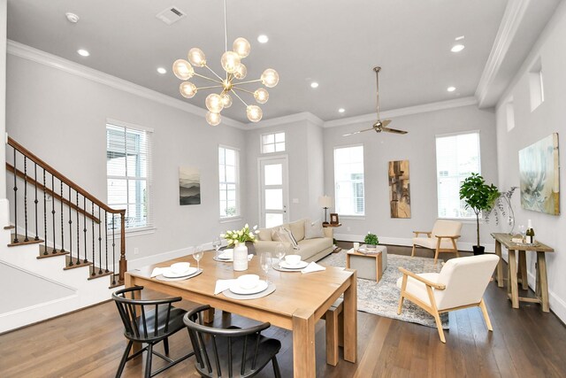 dining room with ornamental molding, dark hardwood / wood-style floors, and ceiling fan with notable chandelier