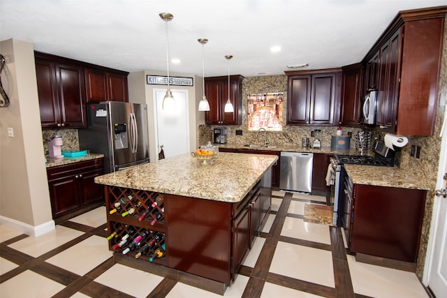 kitchen with pendant lighting, a center island, sink, stainless steel appliances, and backsplash