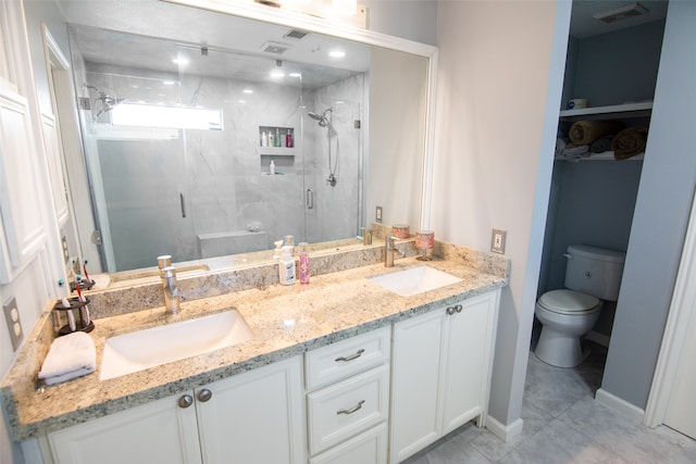 bathroom featuring vanity, tile patterned flooring, toilet, and a shower with door