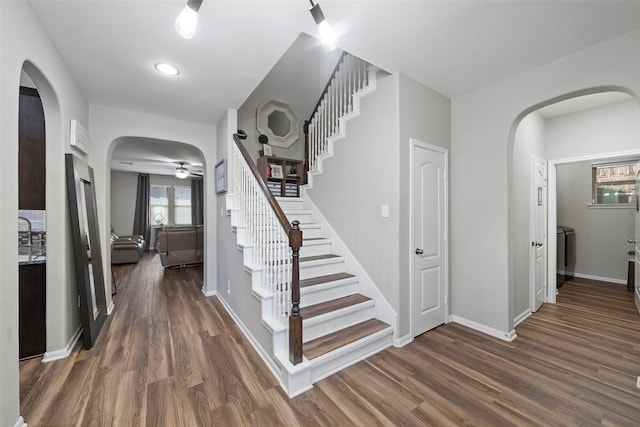 stairs with ceiling fan, washer / clothes dryer, and hardwood / wood-style flooring