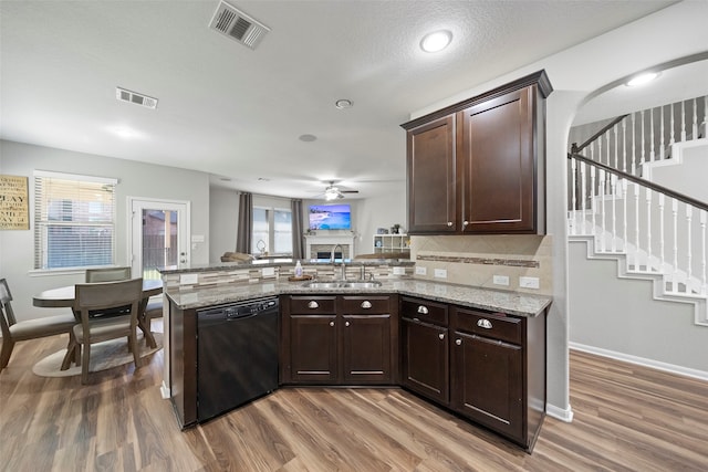 kitchen featuring dishwasher, kitchen peninsula, hardwood / wood-style flooring, and sink