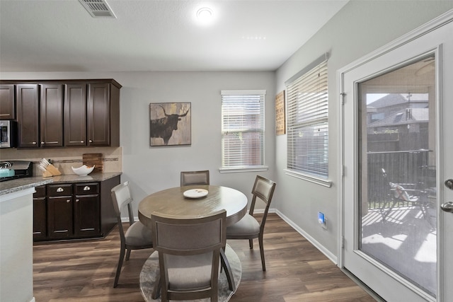 dining area featuring dark hardwood / wood-style flooring