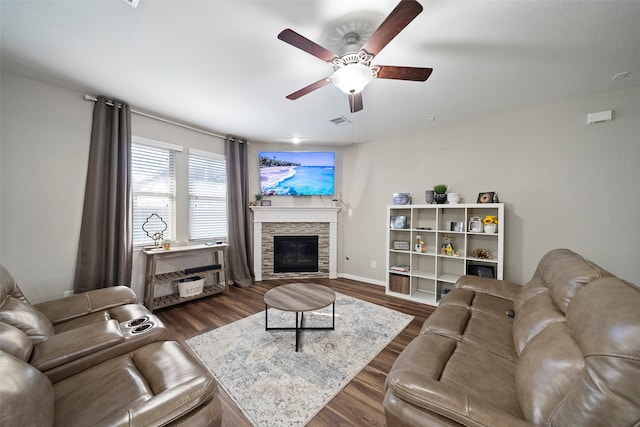 living room with a fireplace, dark hardwood / wood-style flooring, and ceiling fan