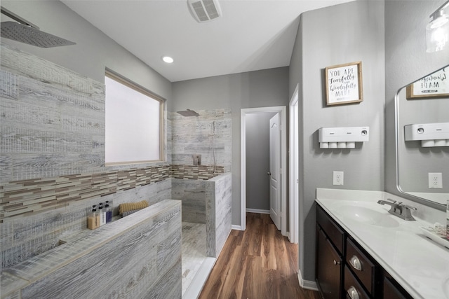 bathroom with vanity, a shower, and hardwood / wood-style flooring