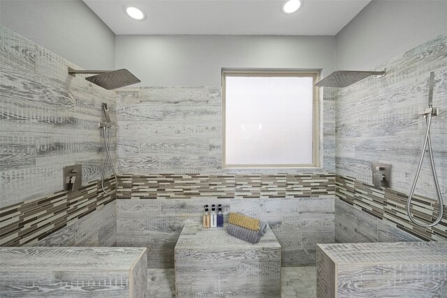 bathroom with tile walls and a shower