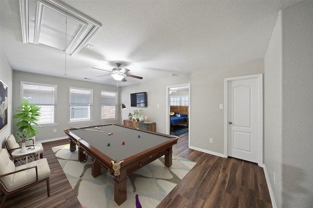 game room with a textured ceiling, pool table, ceiling fan, and dark hardwood / wood-style flooring