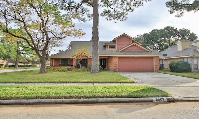 view of front of property with a front lawn and a garage