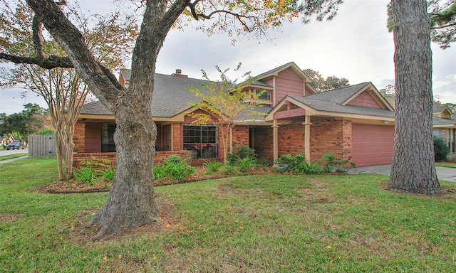 view of front of home with a garage and a front lawn