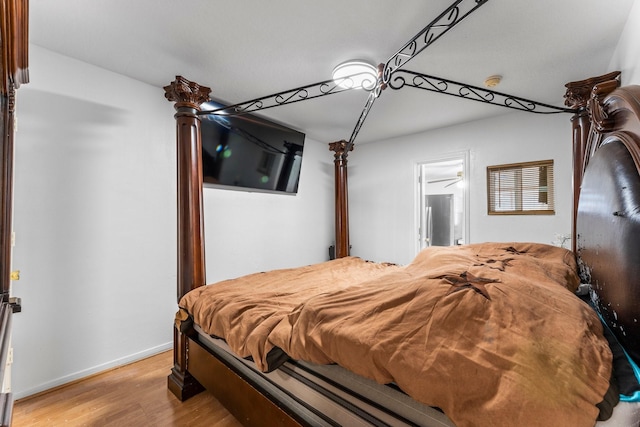 bedroom with light wood-style flooring and baseboards