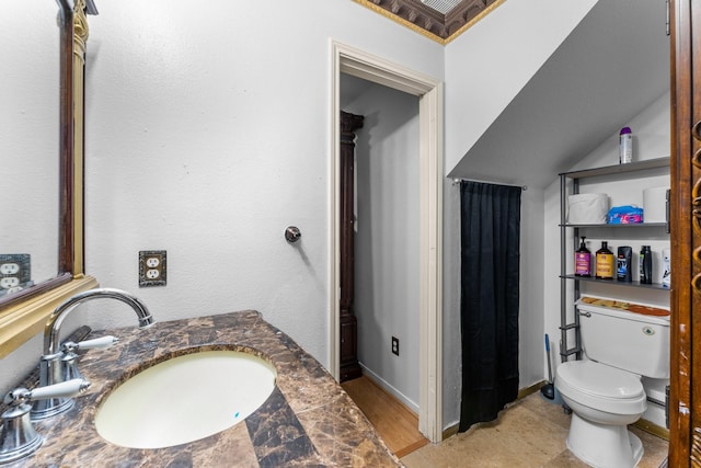 bathroom with toilet, baseboards, and a sink