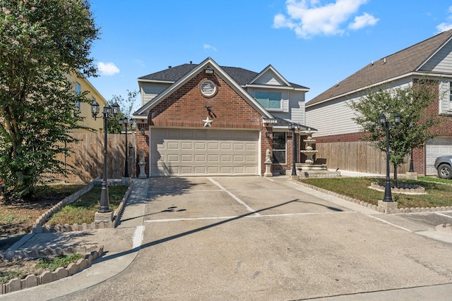 traditional home with concrete driveway, brick siding, and fence
