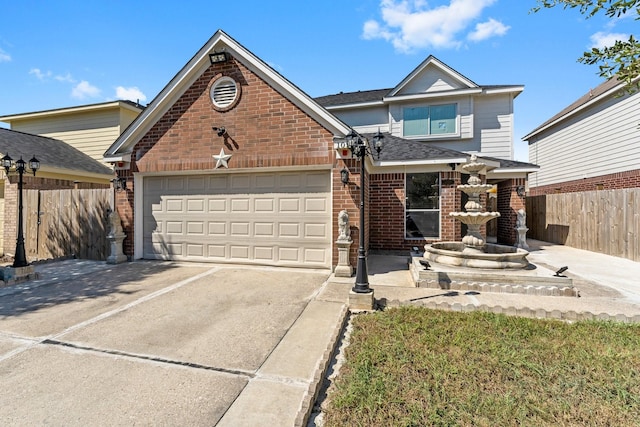 traditional-style home with brick siding, driveway, a garage, and fence