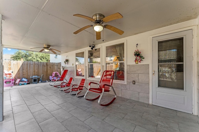 view of patio / terrace featuring fence and a ceiling fan