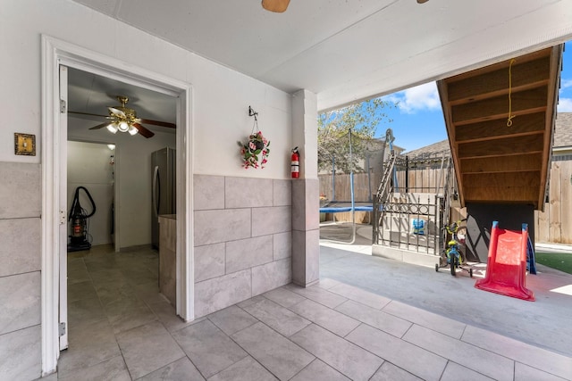 view of patio with a fenced backyard and a trampoline
