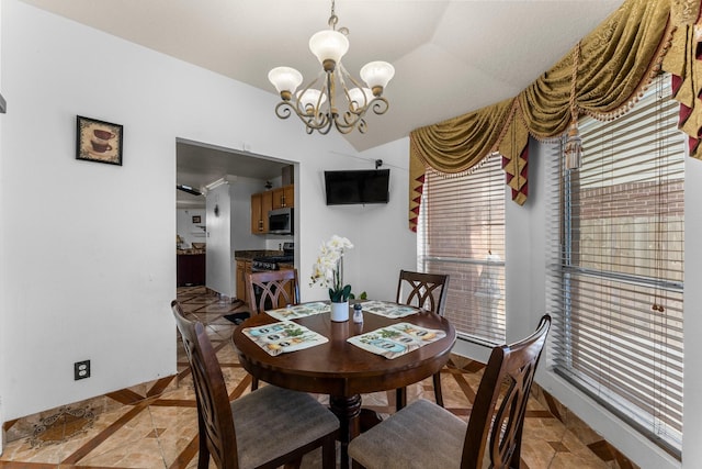 dining area with a chandelier and baseboards