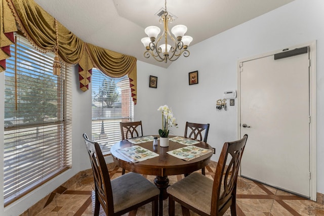 dining space with lofted ceiling, visible vents, stone tile floors, and a notable chandelier