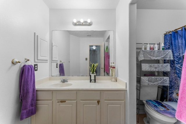 bathroom with toilet and vanity