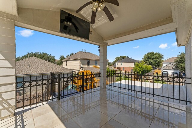 view of patio / terrace with fence, a residential view, and ceiling fan