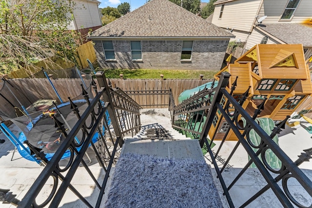 view of patio / terrace featuring a fenced backyard and a playground