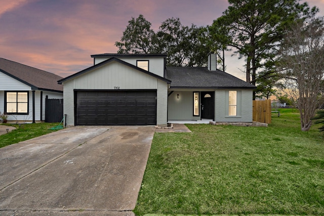 view of front of house with a lawn and a garage