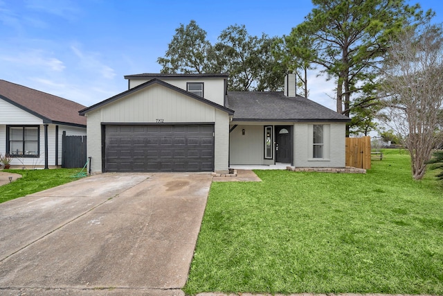 view of front of property featuring a front lawn and a garage