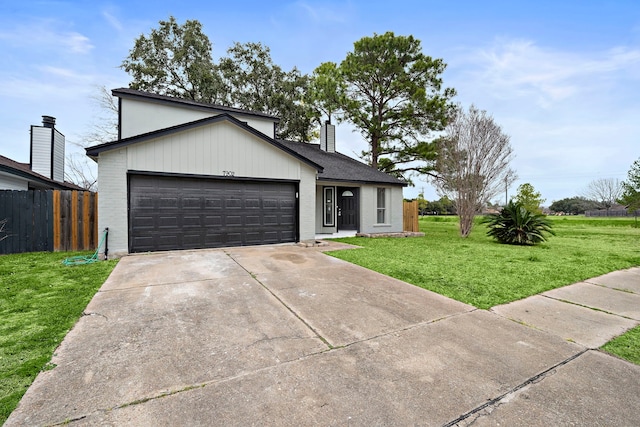 view of front of property featuring a garage and a front lawn