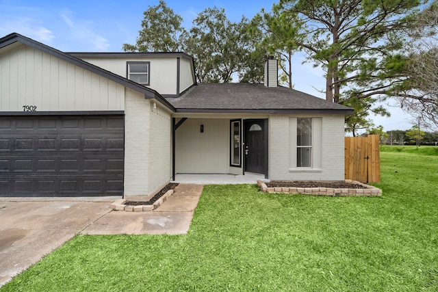 view of front facade with a front lawn and a garage