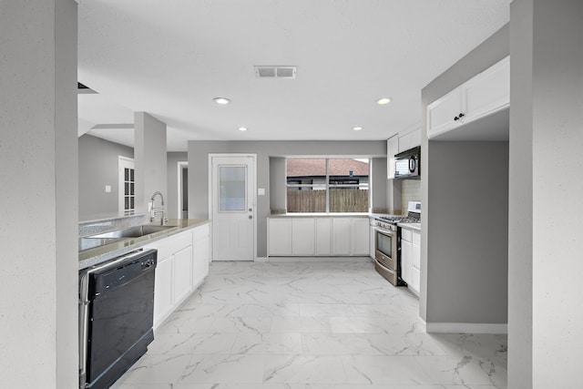 kitchen featuring black appliances, white cabinetry, and sink