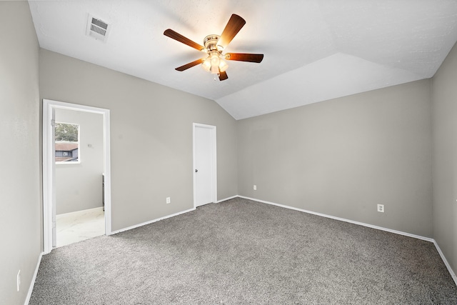 unfurnished bedroom featuring lofted ceiling, ceiling fan, and carpet floors