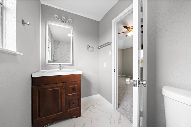 bathroom with ceiling fan, vanity, and toilet