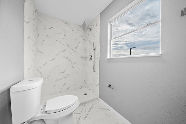 bathroom with toilet and tiled shower