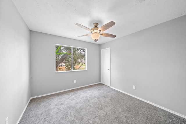 empty room featuring ceiling fan, a textured ceiling, and carpet flooring